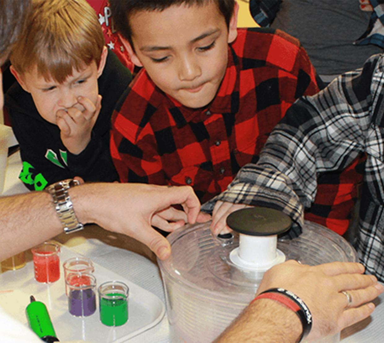 children looking at science themed booth