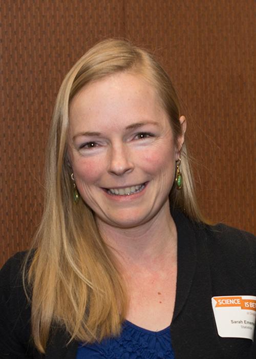 Sarah Emerson in front of wooden backdrop