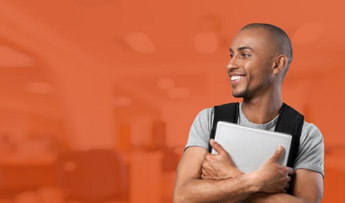 male student in front of orange-filtered classroom