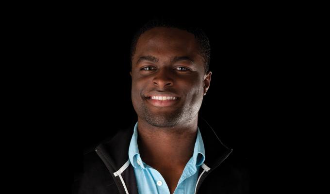 Maduka Ogba standing in front of black backdrop