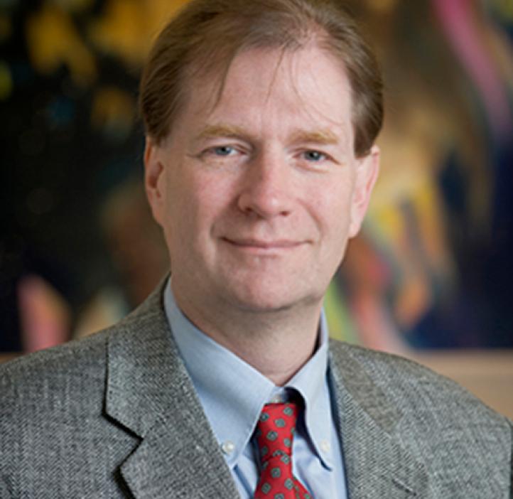 Adrian Gombart in front of painted backdrop