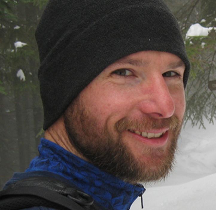 Mark Novak standing in snowy forest